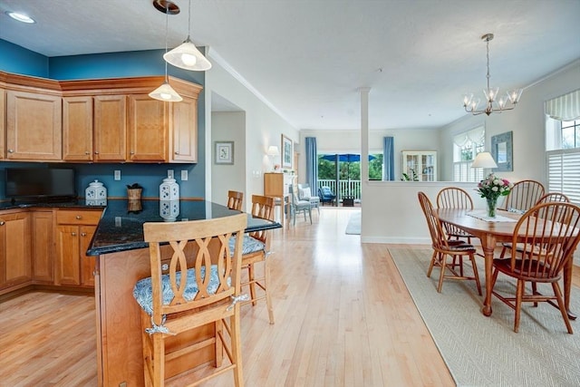dining space with baseboards, a wealth of natural light, and light wood-type flooring