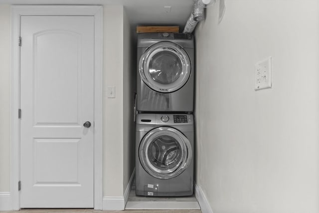 clothes washing area featuring stacked washer / drying machine