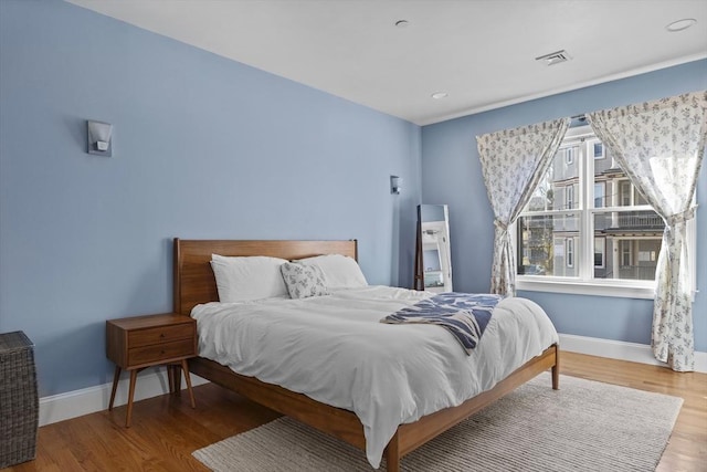 bedroom with hardwood / wood-style floors