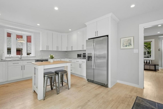21 Milton Rd, Quincy, MA 02171 - kitchen with stainless steel appliances, white cabinets, light wood-style floors, and recessed lighting