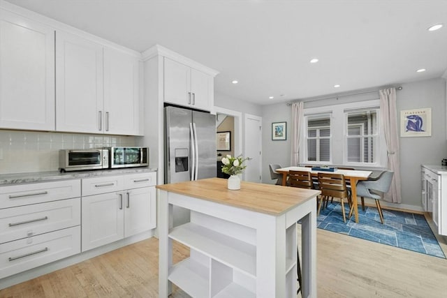 21 Milton Rd, Quincy, MA 02171 - kitchen featuring stainless steel refrigerator with ice dispenser, open shelves, light wood-style flooring, white cabinets, and recessed lighting