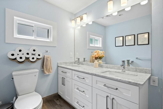 21 Milton Rd, Quincy, MA 02171 - bathroom featuring double vanity, toilet, wood finished floors, and baseboards