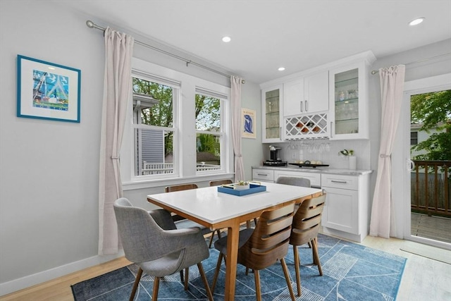 21 Milton Rd, Quincy, MA 02171 - dining area with a bar, healthy amount of natural light, light wood-style floors, recessed lighting, and baseboards