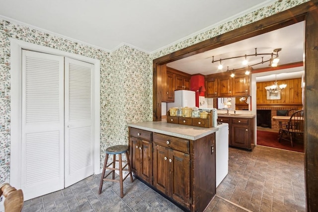 197-199 Main St, Chelmsford, MA 01863 - kitchen featuring wallpapered walls, a chandelier, a peninsula, light countertops, and crown molding