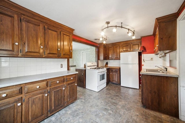 197-199 Main St, Chelmsford, MA 01863 - kitchen featuring white appliances, a sink, backsplash, light countertops, and brown cabinetry