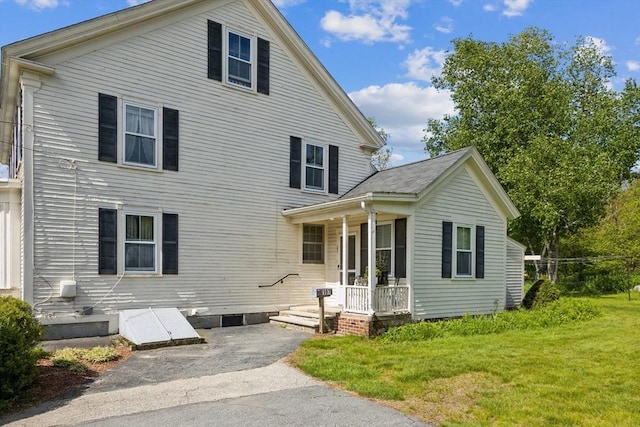 197-199 Main St, Chelmsford, MA 01863 - view of front of house with a front yard and covered porch