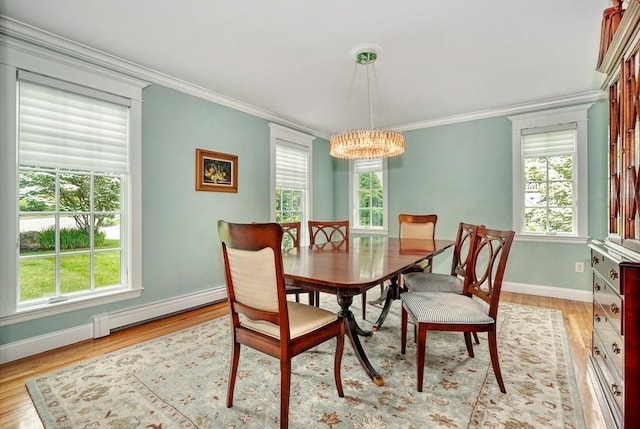 24 Cory Ln, Reading, MA 01867 - dining area with baseboard heating, a chandelier, crown molding, baseboards, and light wood-type flooring