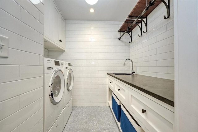 24 Cory Ln, Reading, MA 01867 - laundry area with washing machine and clothes dryer, cabinet space, and tile walls