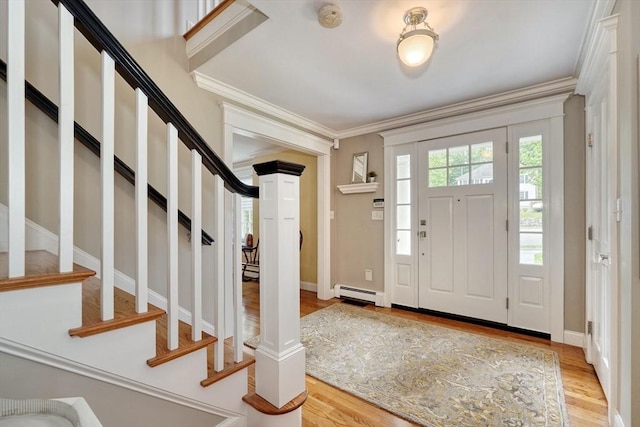 24 Cory Ln, Reading, MA 01867 - entrance foyer with baseboard heating, light wood-type flooring, ornamental molding, stairs, and baseboards
