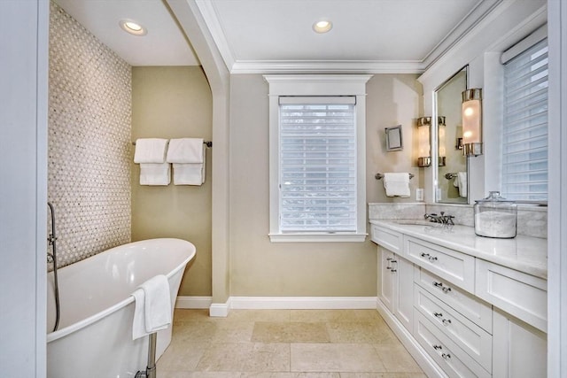 24 Cory Ln, Reading, MA 01867 - full bathroom featuring baseboards, vanity, a soaking tub, healthy amount of natural light, and ornamental molding