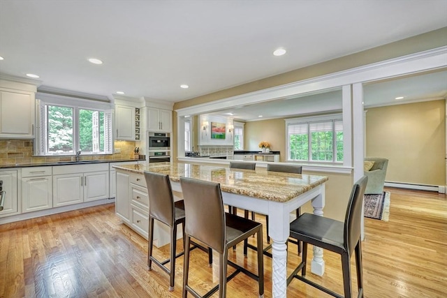 24 Cory Ln, Reading, MA 01867 - kitchen featuring plenty of natural light, a sink, tasteful backsplash, light wood-type flooring, and recessed lighting