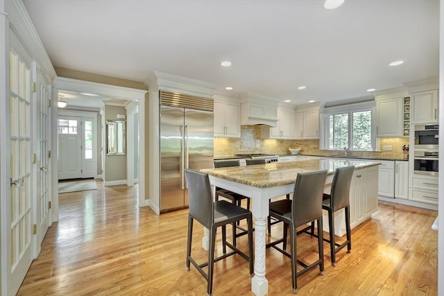 24 Cory Ln, Reading, MA 01867 - kitchen featuring stainless steel appliances, a sink, crown molding, plenty of natural light, and tasteful backsplash