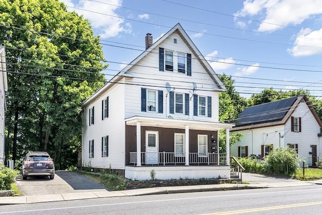 1130 Water St, Fitchburg, MA 01420 - view of front facade with covered porch and a chimney