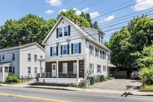1130 Water St, Fitchburg, MA 01420 - traditional style home featuring a porch and a chimney