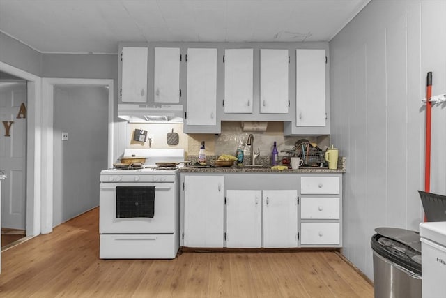1130 Water St, Fitchburg, MA 01420 - kitchen featuring white range with gas stovetop, under cabinet range hood, light wood-type flooring, and white cabinets