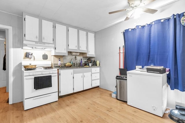 1130 Water St, Fitchburg, MA 01420 - kitchen featuring white range with gas stovetop, under cabinet range hood, light wood-style floors, ceiling fan, and white cabinets