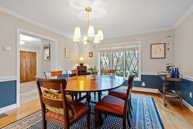15 Saxon Ln, Shrewsbury, MA 01545 - dining area with light wood-style flooring, ornamental molding, a chandelier, and a baseboard heating unit