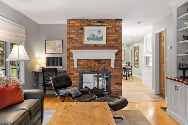 15 Saxon Ln, Shrewsbury, MA 01545 - living area with light wood-style flooring, a fireplace, and built in shelves