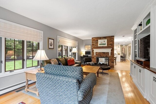 15 Saxon Ln, Shrewsbury, MA 01545 - living area featuring light wood finished floors and a fireplace