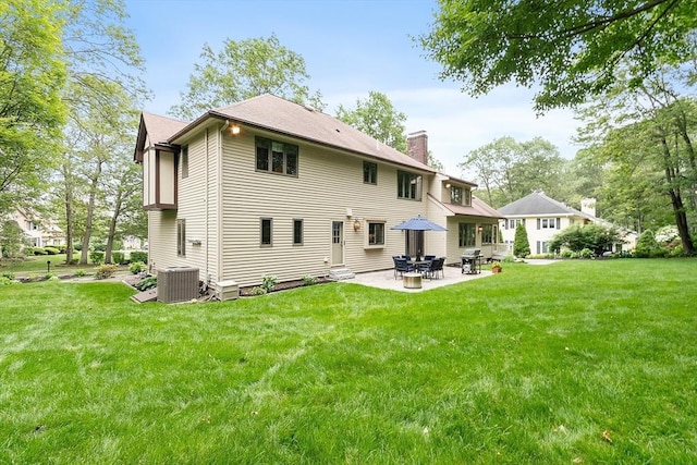 15 Saxon Ln, Shrewsbury, MA 01545 - rear view of house with a chimney, a patio, a lawn, and entry steps