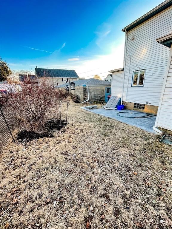 view of yard with fence and a patio