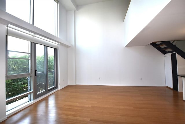1 Earhart St Unit 320, Cambridge, MA 02141 - unfurnished living room with wood finished floors and a high ceiling