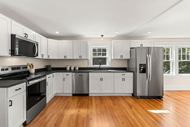 kitchen featuring light wood-style floors, stainless steel appliances, and a healthy amount of sunlight