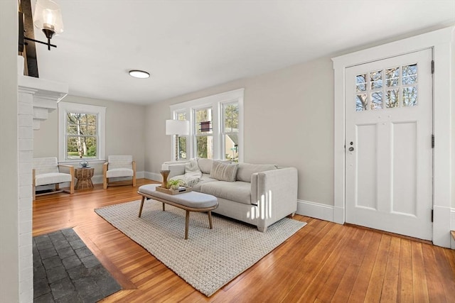 living area featuring light wood-style floors and baseboards