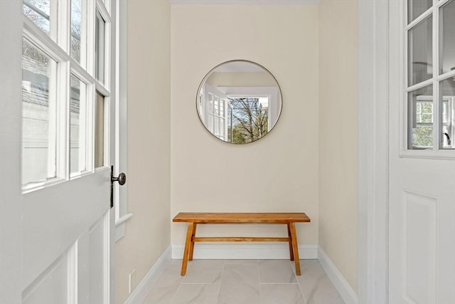 doorway featuring baseboards and marble finish floor