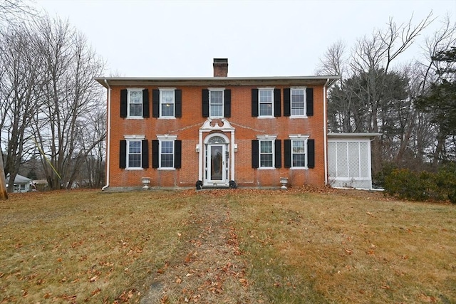 colonial home with a front lawn