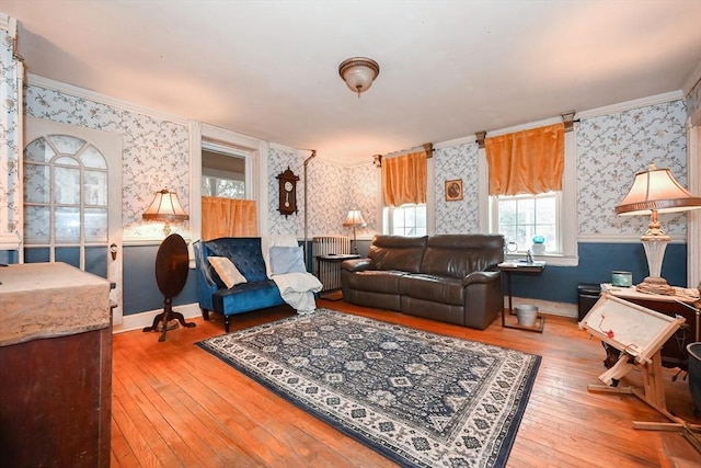 living room with hardwood / wood-style flooring and crown molding