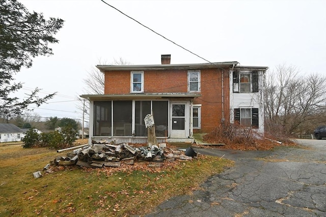 back of house with a sunroom