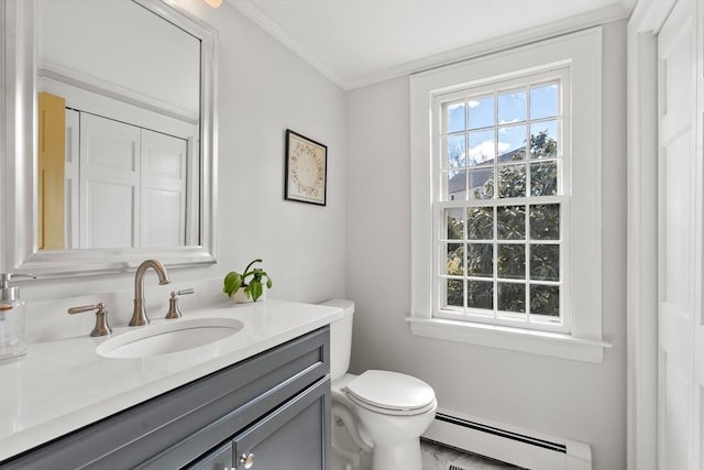 bathroom featuring a healthy amount of sunlight, vanity, toilet, and a baseboard heating unit