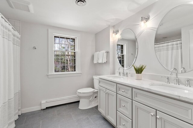 bathroom with baseboard heating, toilet, visible vents, and a sink