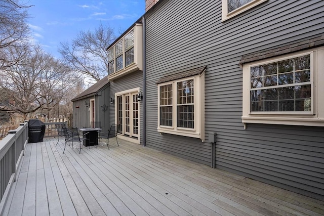 wooden deck with outdoor dining area and central AC