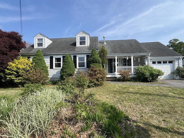 70 Puritan Rd, Bourne, MA 02532 - cape cod-style house with an attached garage, covered porch, driveway, a front lawn, and roof with shingles