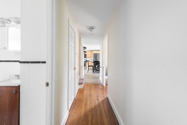 70 Puritan Rd, Bourne, MA 02532 - hallway featuring light wood-style floors and a sink