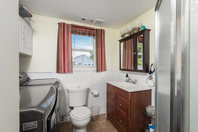 70 Puritan Rd, Bourne, MA 02532 - bathroom with vanity, washer and clothes dryer, and toilet