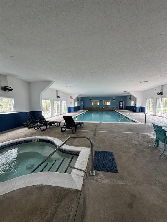 pool with an indoor in ground hot tub