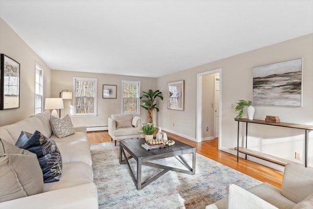 living room featuring light hardwood / wood-style floors and a baseboard heating unit