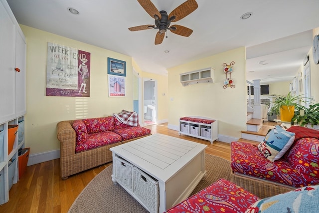 living room featuring ceiling fan and light hardwood / wood-style flooring