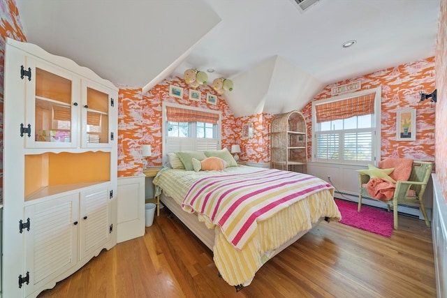 bedroom featuring hardwood / wood-style flooring, multiple windows, and vaulted ceiling