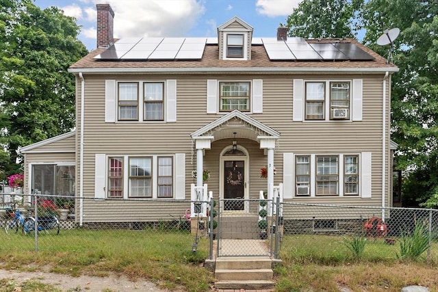 colonial-style house with solar panels and cooling unit