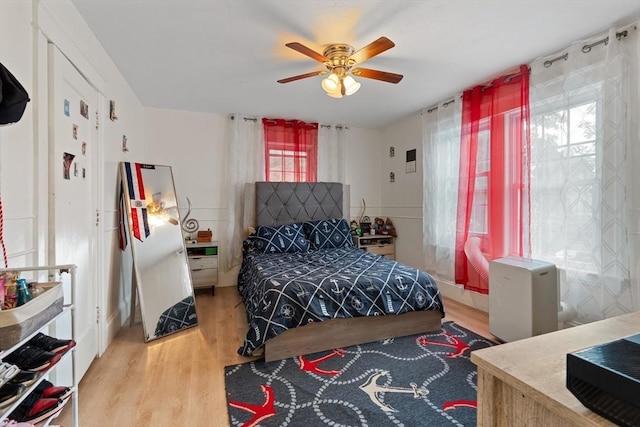 bedroom with ceiling fan and hardwood / wood-style flooring