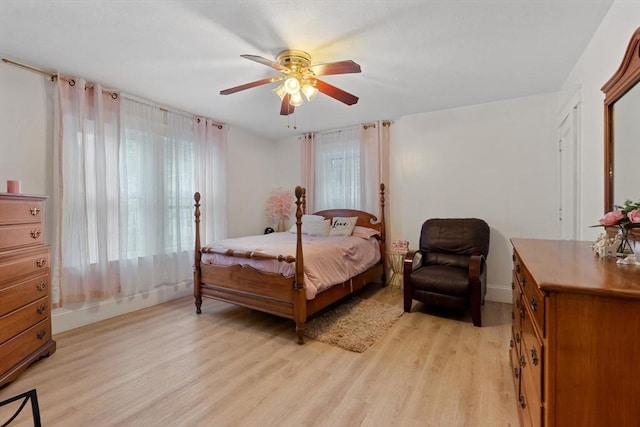 bedroom with ceiling fan and light hardwood / wood-style flooring