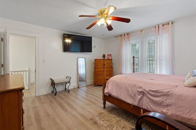 bedroom with ceiling fan and light hardwood / wood-style floors