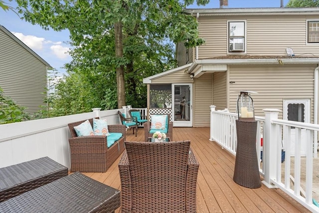 wooden deck with outdoor lounge area and a sunroom