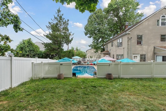 view of yard with a fenced in pool