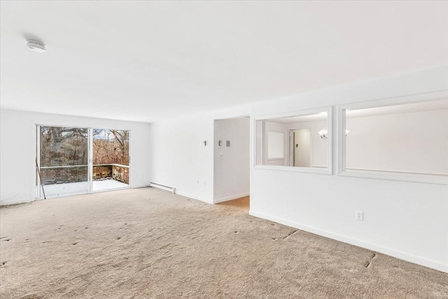 spare room with a baseboard radiator and carpet