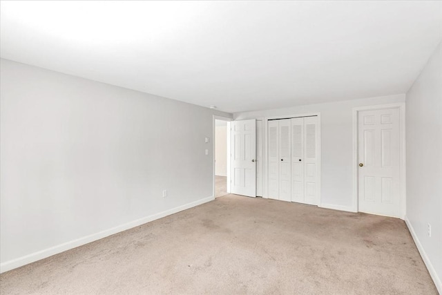 unfurnished bedroom featuring a closet and carpet floors